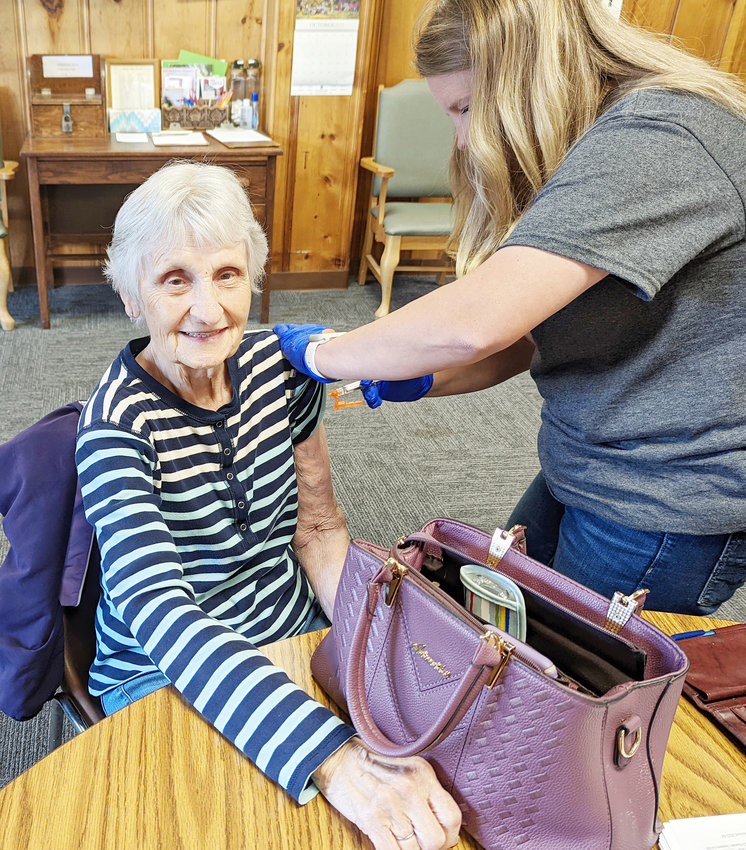 Betty Lilly showed some arm to get this years flu vaccine from Jill Lewis of the ELVPHD. She has gotten it every year, and reports that she hasn't had the flu.