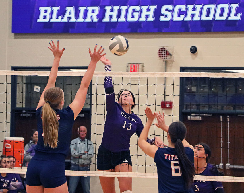 The Bears' Schuyler Roewert, middle, spikes the ball Tuesday against Norris at Blair High School.