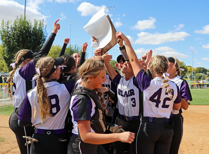 The Blair softball team celebrates with its Class B-2 District Final championship plaque Friday at the Youth Sports Complex. The Bears beat Crete 10-0 and 5-2, winning the best-of-three series and qualifying for the NSAA State Softball Championships in Hastings.