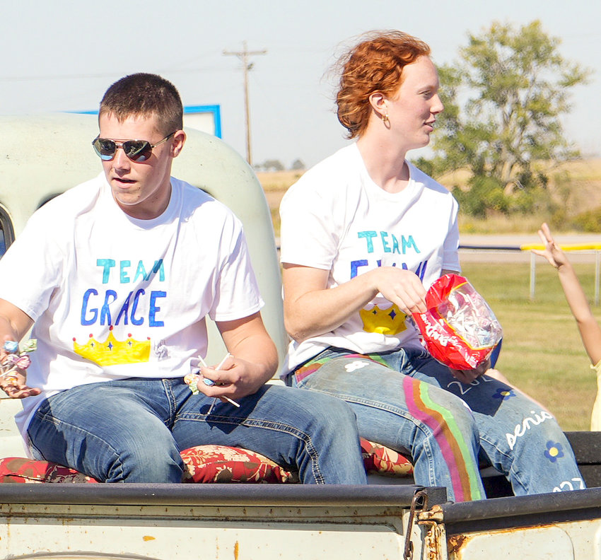 Candidates Evan Hartman and Grace Schlueter throw candy as they ride through the Homecoming Parade.