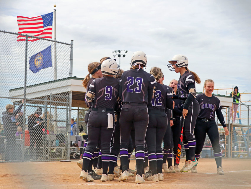 The Blair High School softball team celebrates Joslyn Policky's two-run home run at the plate Friday in Hastings. The second-inning runs were the only runs the Bears scored during a 13-2 loss to Elkhorn.