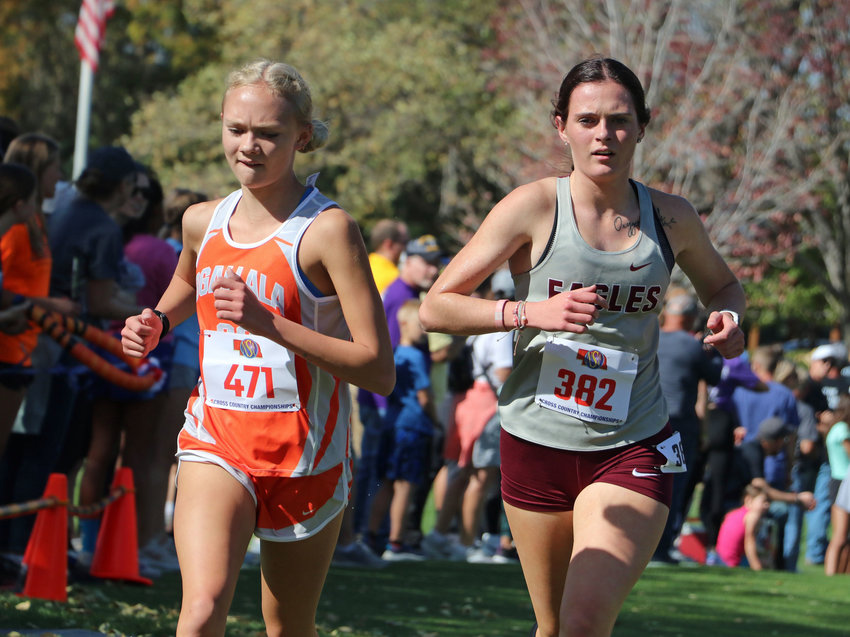 Arlington senior Keelianne Green, right, competes against Ogallala's Lindee Henning on Friday during the NSAA State Cross-Country Championships in Kearney. Green bested Henning for her second-straight state title in Class C.