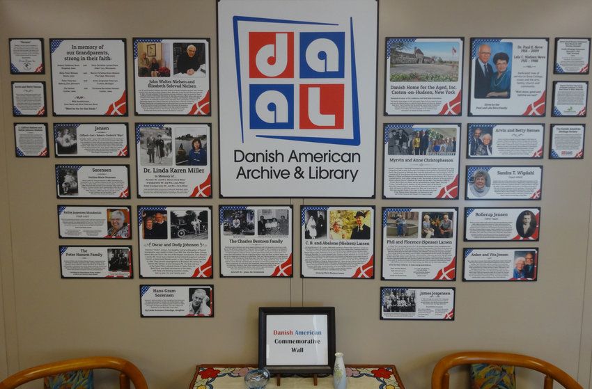 The Danish American Commemorative Wall at the Danish American Archive and Library displays stories and pictures of influential individuals and institutions of Danish American history.