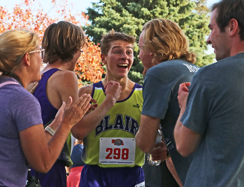 Blair's Ted Lueders, middle, reacts to news of the Bears' third-place team finish Friday at Kearney Country Club.