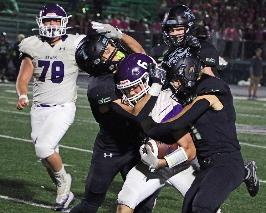 Skyhawks combine to tackle Blair sophomore Brock Templar (6) as Triston Clausen, left, follows the play Friday at Omaha Skutt. The home team won 21-7, while the Bears closed out the fall 5-5.