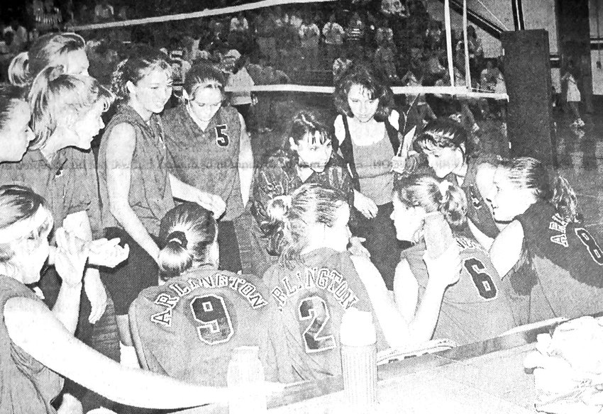 The 1996 Arlington Eagles huddle around coaches Jennifer Hascall and Marla Ryan during the conference volleyball tournament.