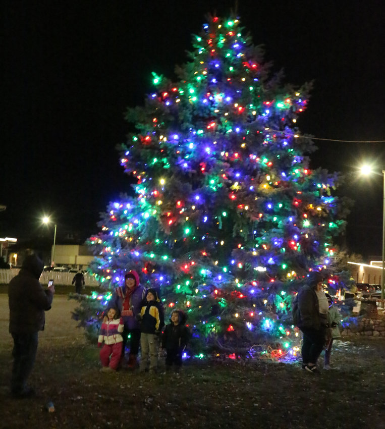 Families have their pictures taken in front of the Christmas tree outside of Blair City Hall following the tree lighting at the Tannenbaum event on Nov. 17.
