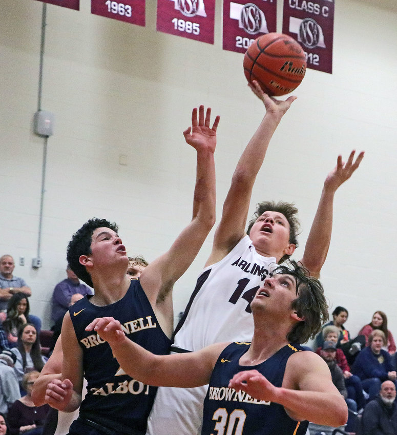 Eagles freshman Oliver Ladehoff, middle, puts up a shot between a pair of Omaha Brownell-Talbot defenders Saturday at Arlington High School.