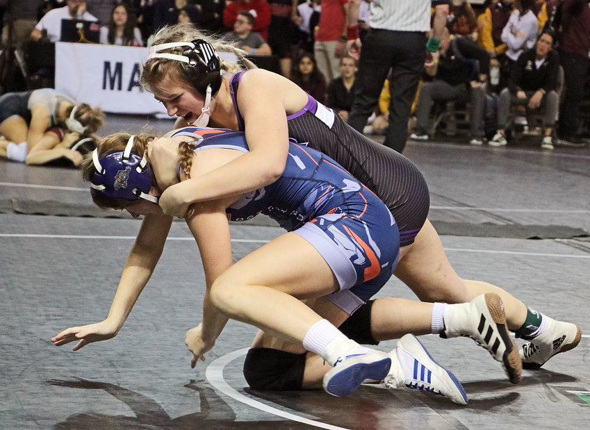Blair's Savanah Roan, top, takes Sierra Wieland of CBCSD Co-Op to the mat Friday during the Council Bluffs Wrestling Classic at the Mid-America Center.