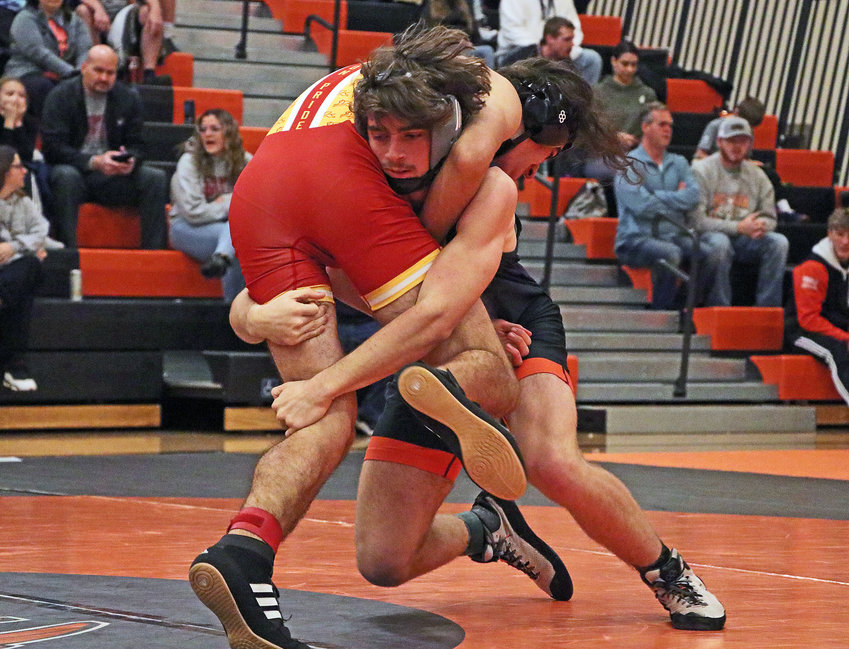 The Pioneers' AJ Duros, facing, scores a takedown against Omaha Roncalli's Nathan Evans on Saturday at Fort Calhoun High School.