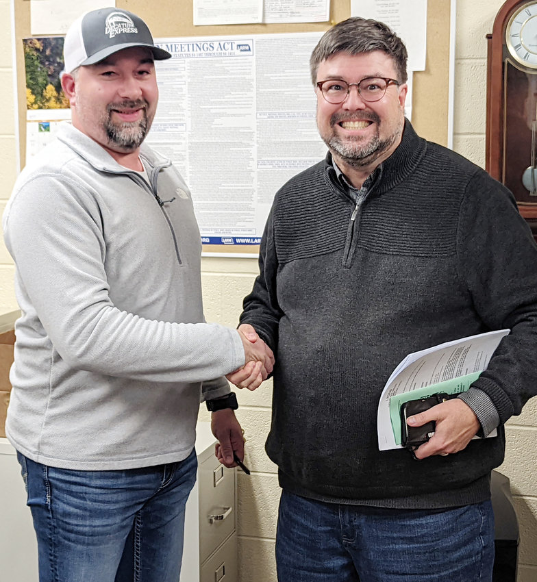 After 16 years of serving the community of Lyons as mayor (right) Andy Fuston is happy to shake the hand of new Mayor (left) Kyle Brink.