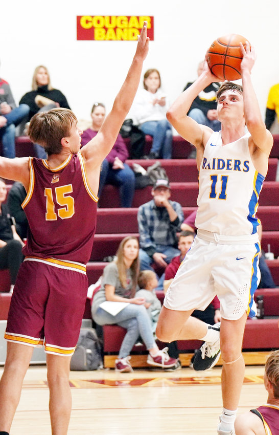 Kolton Kriete #11 drives through the Cougar defense and goes up for the shot at close range.