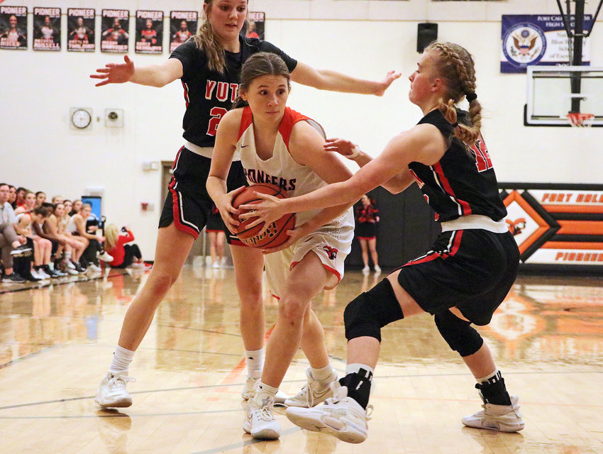 Pioneers guard Maddy Tinkham, middle, attempts to pass out of Yutan trap Tuesday at Fort Calhoun High School.