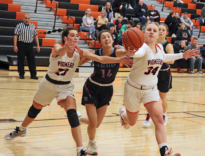 The Pioneers' Bria Bench, left, and Jovi Greiner, right, contend for a loose ball with Ralston's Lexi Paskach on Tuesday at Fort Calhoun High School.