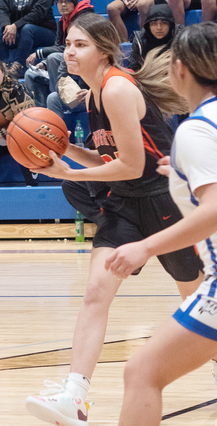 Looking to pass the ball, Valerie Lierman eyes the court vs. Winnebago.