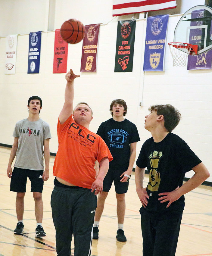 Adam Bannister, second from left, takes a shot Dec. 19 during a Fort Calhoun Unified Basketball Team practice at FCHS. He is joined by teammates Colton Kendall, from left, Owen Miller and Cody Seefus.