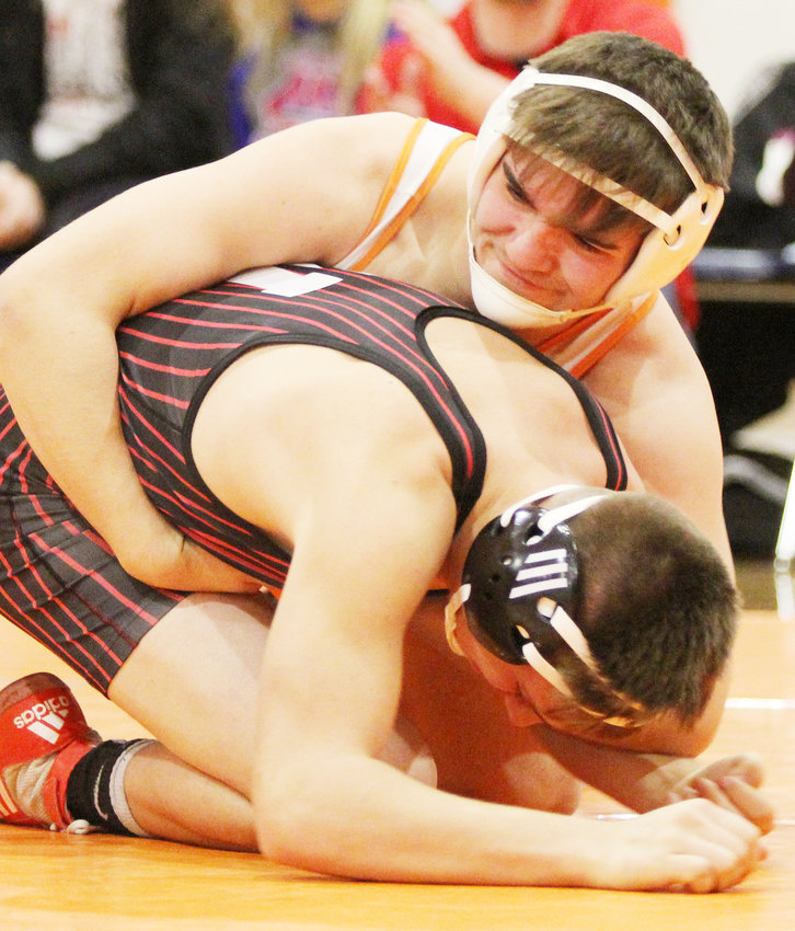 Tristen Coates maneuvers to turn his opponent over to eventually get the pin against Auden Sellin of Winside.