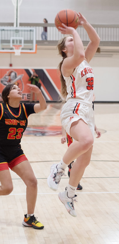 Speeding past defenders, Morgan Ray puts in a layup in the paint.