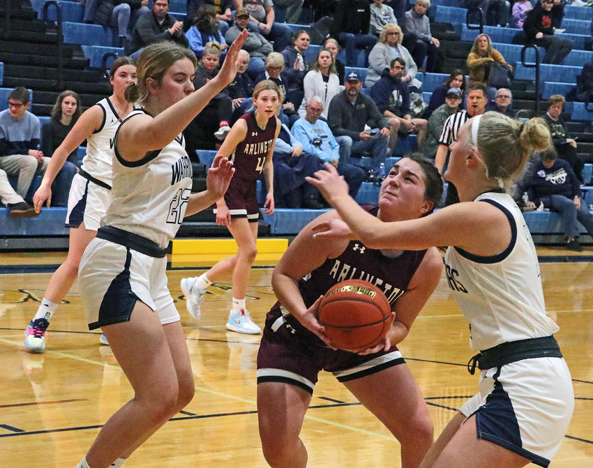 Arlington's Taylor Arp, middle, looks for room in the lane against the Warriors on Dec. 30 at Lincoln Lutheran.