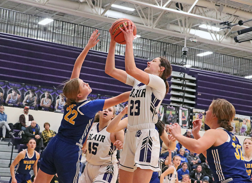 The Bears' Addie Sullivan, middle, pulls down an offensive rebound in front of Wahoo's Sammy Leu (22) on Tuesday at Blair High School.