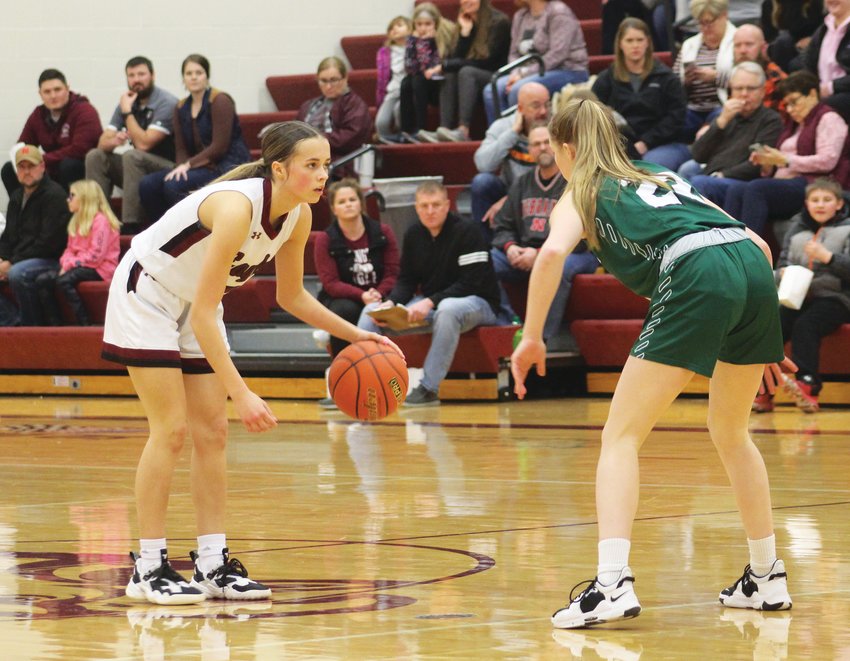 Arlington freshman Emme Timm (left) surveys the floor during the Eagles' 38-30 win over Syracuse on Thursday. Timme finished the game with 11 points, leading the team in the scoring column.