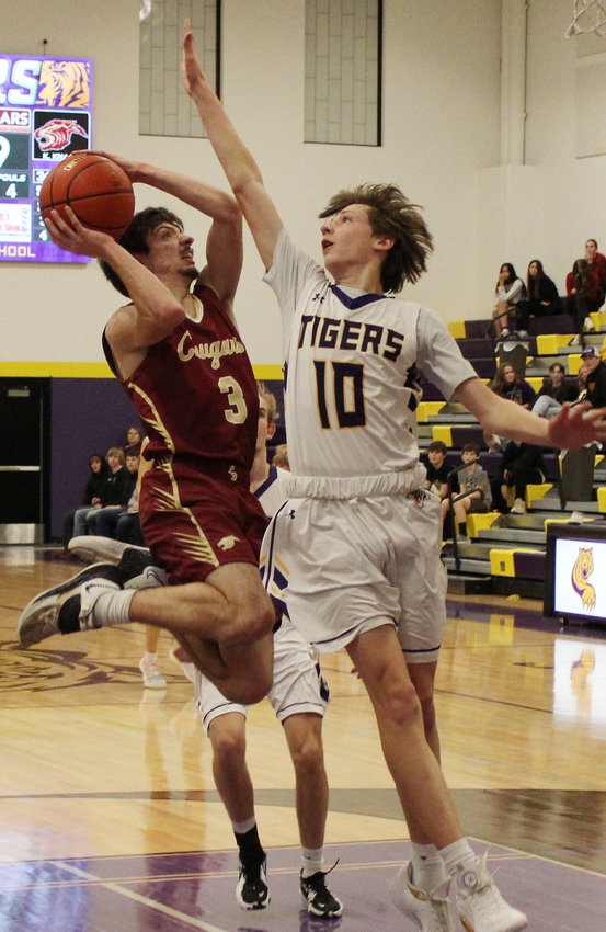 Caleb Schlichting gets a fourth quarter basket over the challenge of the Tigers' Griffin Breckenridge.
