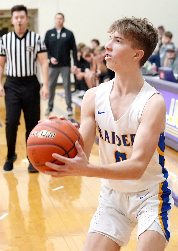 All eyes are on Truman Young #0 as he takes his time and sinks the 3-point shot in the first round of action against Arlington in the Capitol Conference Tournament.