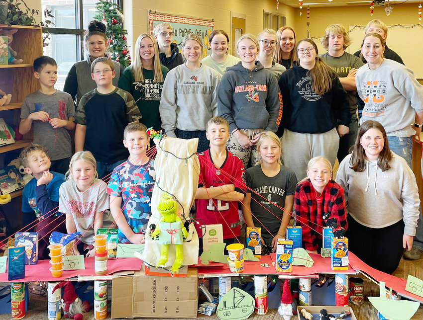 Elementary students joined the high schoolers in working together to compete as houses to collect donated food items for the food pantry. Pictured are: (front from left) Tyler Brands, Adalene Meyer, Tucker Wood, Austin Lechtenberg, Ainsley Meyer, Ava Rennerfeldt, and Josie Peterson; (middle from left) Arthur Pearson, Miles Pickell; (middle big kids) Abby Paul, Ella Martindale, Bailey Denton, Carlee Warren, Gracie Klausen, and Mrs. Angie Meyer; (back from left) Landon Ehlers, Emma Johanson, Korene Johnson, Brandi Helzer, Preston Novak, Tate Penke.