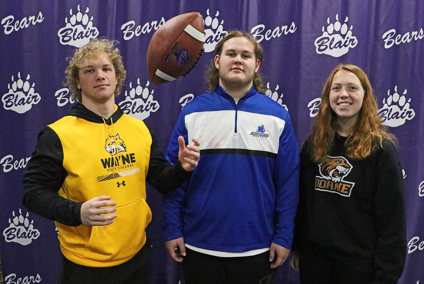 Blair High School seniors Dane Larsen, from left, Seagan Packett-Trisdale and Norah Cloudt signed with college sports team Wednesday morning.