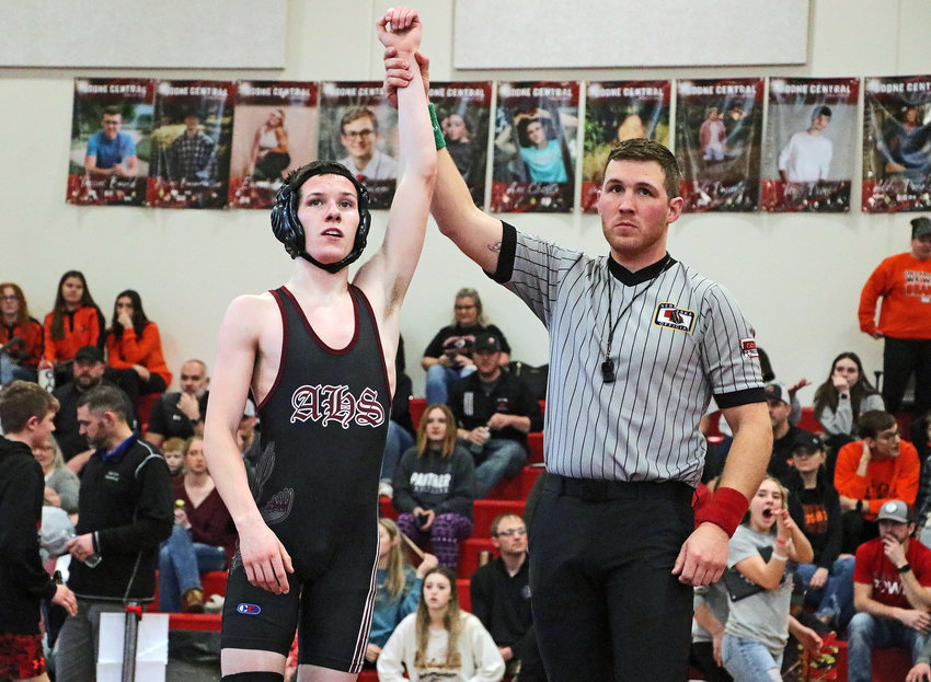 Arlington 113-pounder Trey Hill has his hand raised Saturday in Albion after qualifying for state during the Class C District 1 Tournament. The Eagle was one of three AHS state qualifiers.