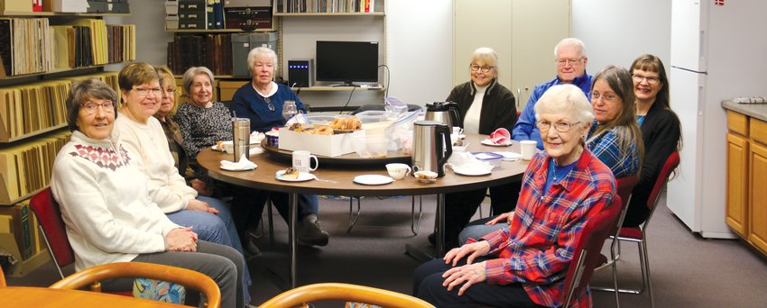 A group of volunteers gather at the Danish American Archive and Library every Tuesday to sort through obituaries, Dana College files and collections.