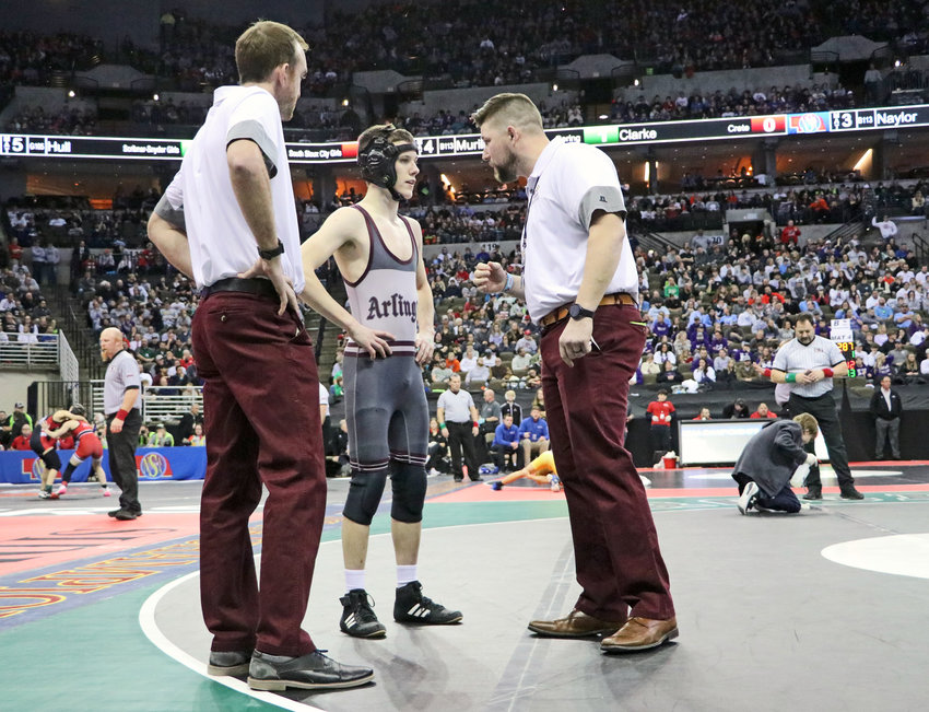 Arlington 113-pounder Trey Hill, middle, speaks with coaches Tyler Stender, left, and Doug Hart on Friday during a break in the action at the CHI Health Center in Omaha.
