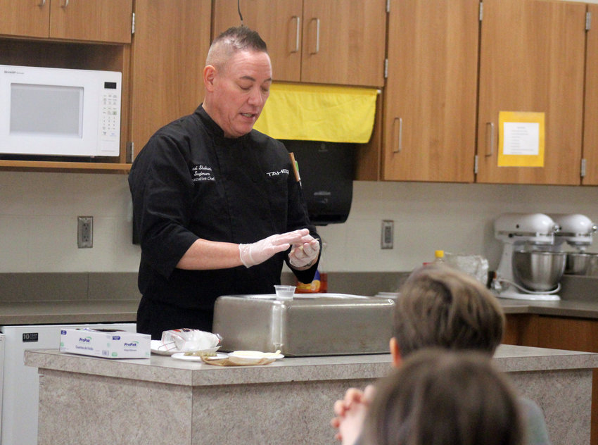 John Sugimura, a Nisei Japanese trained chef, showed culinary students at Blair High School how to make gyoza, or Japanese dumplings, during class Thursday afternoon.