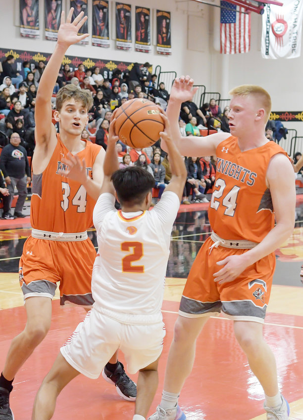 Braden Selk and Braylon Anderson team up to corner the  Omaha Nation player.