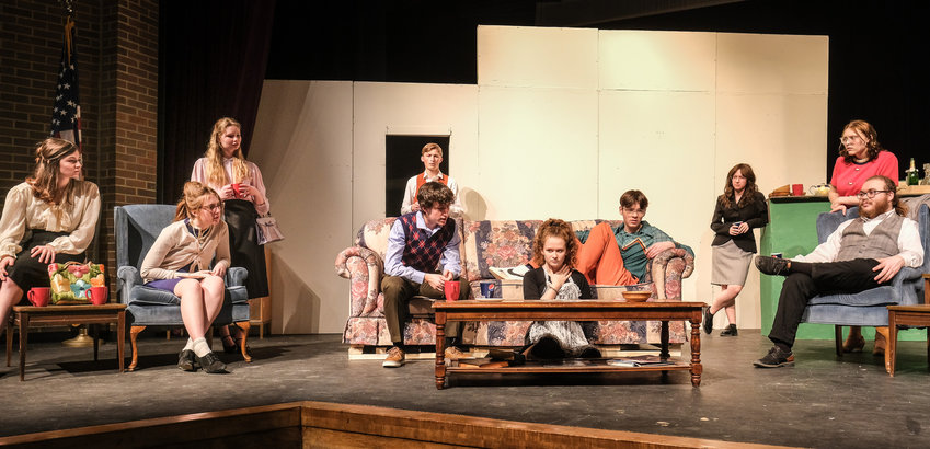 Alice Thomas, who plays Graciela in Blair High School's spring play &quot;Artiface,&quot; reads the cards and predicts that gun shots will be fired. From left, Adi Kunz as Diana, Ruby Gutzmann as Judith Fontaine, Bailey Domann as Cynthia, Austin Back as Richard, Jacob Lamoureux as Payne Showers, Thomas as Graciela reading cards, Gavin Beal as Trent Matlock, Jacinta Flynn as Emma, Olivia Nelson as Maggie La Rue and Sam Lager as Mick Fitzgerald. .