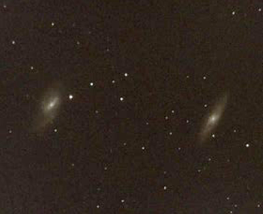 Galaxies Messier 65 and 66 lie deep in space beyond the stars of the constellation Leo the Lion as seen in our March evening sky.