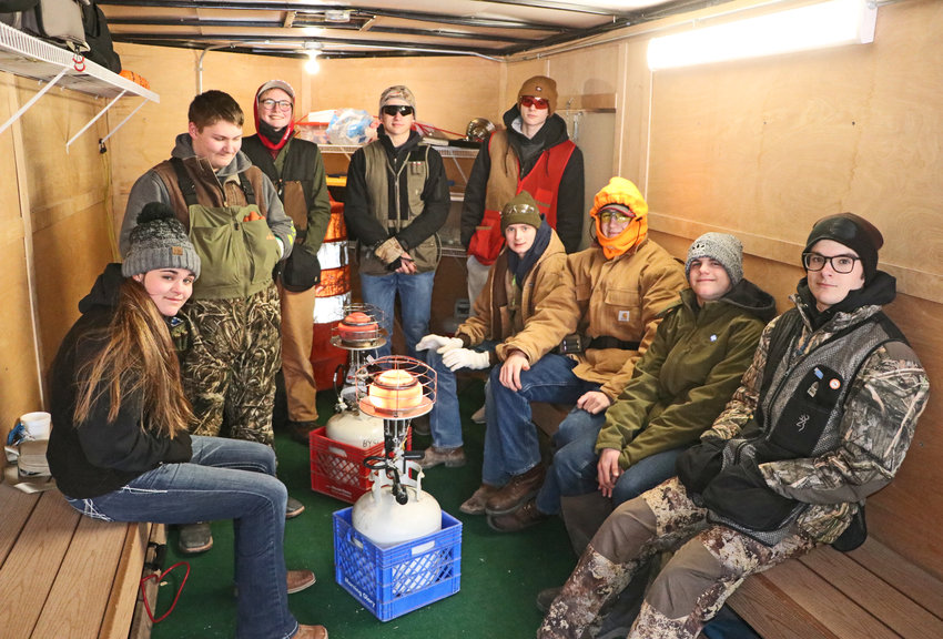 Members of the Blair Youth Shooting Sports team found warmth inside the organization's trailer Saturday during an Eastern Cornhusker Trapshooting Conference shoot at Bellevue Rod and Gun Club range.