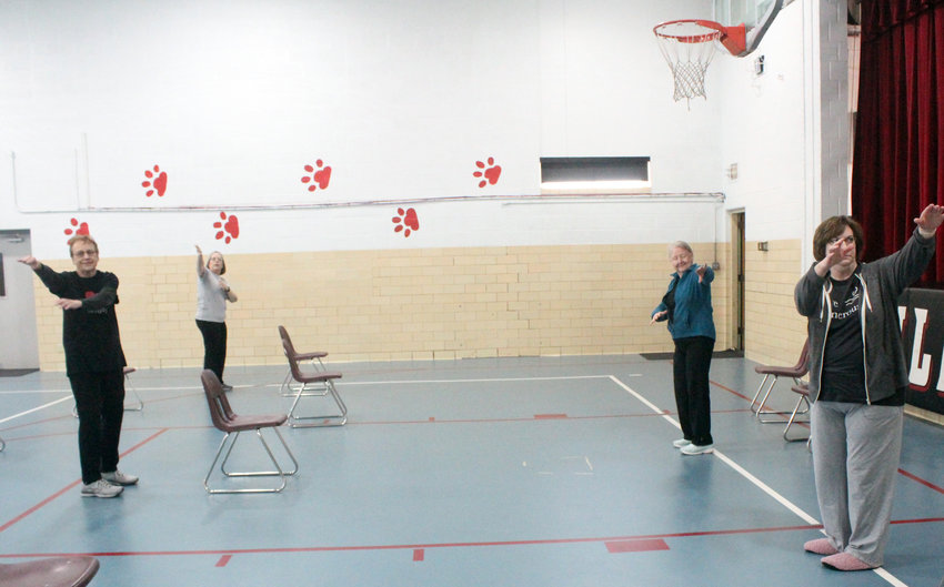 At the beginning of class, Cheryl Kanoy and Susan Green prepare a warm-up for tai chi attendees.