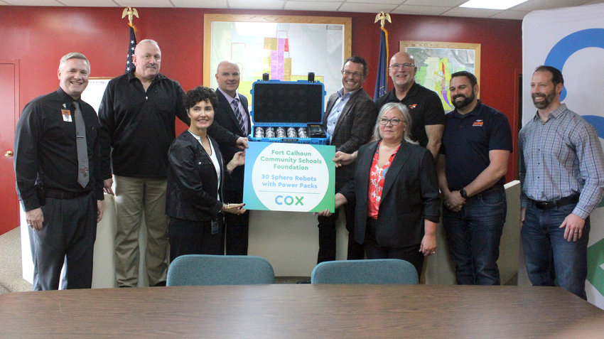 Cox Communications donated 30 sphere robots to the Fort Calhoun Community Schools Foundation March 30 during an event at the Fort Calhoun Library. Pictured from left, Elementary Principal Drew Wagner, Mayor Mitch Robinson, Nebraska and Iowa Cox Vice President Kim Rowell, Supt. Jerry Green, Cox President Mark Greatrex, Foundation President Melissa Ruge, Foundation Director Don Johnson, Council Member John Kelly and Council Member Nick Schuler.