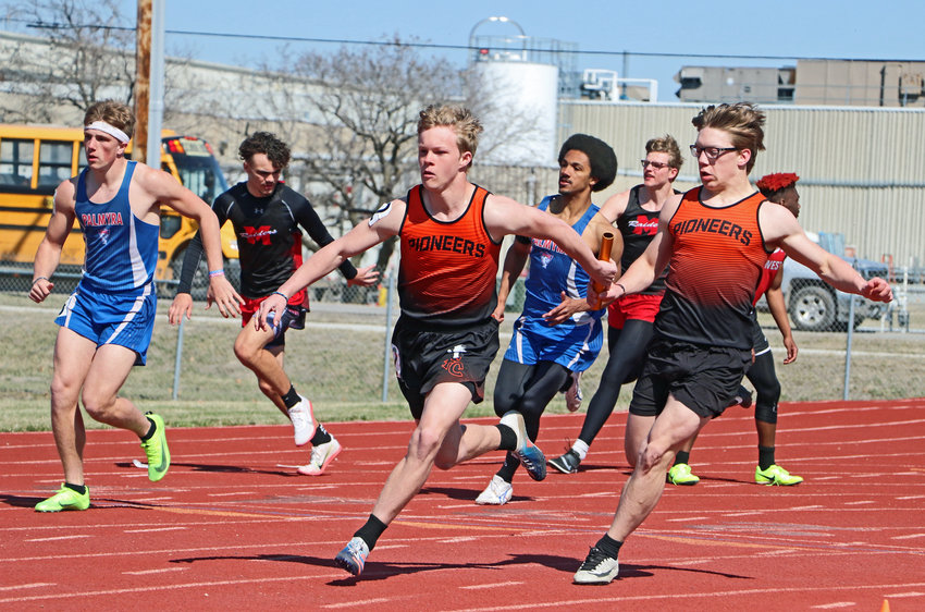 Fort Calhoun sprinter Clayton Bohnenkamp, left, takes a 400-meter relay handoff from Michael Maxon on Thursday at Douglas County West. The Pioneers won the race in 45.44 seconds.
