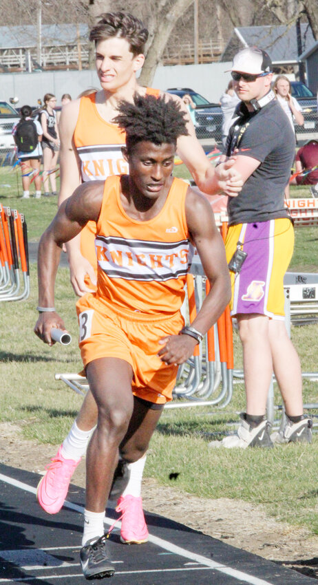 Lincoln Benne hands off the baton to Jeremiah Druckenmiller as the 4x400 relay.  Not pictured are Carter Bousquet and Brayden Selk.  The relay team finished 2nd.