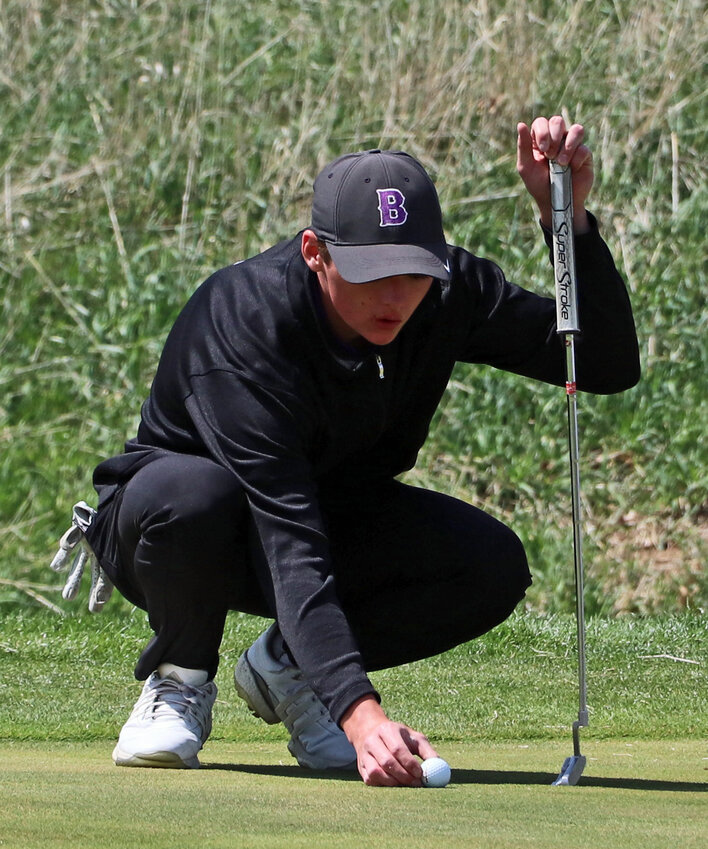Blair senior Easton Chaffee places his ball back on the green Tuesday at River Wilds Golf Club.