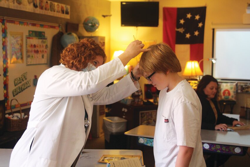 Grant Nelson as &quot;Nelly Whiter&quot; is checked by &quot;Dr. Reed&quot; for head lice during his medical exam.