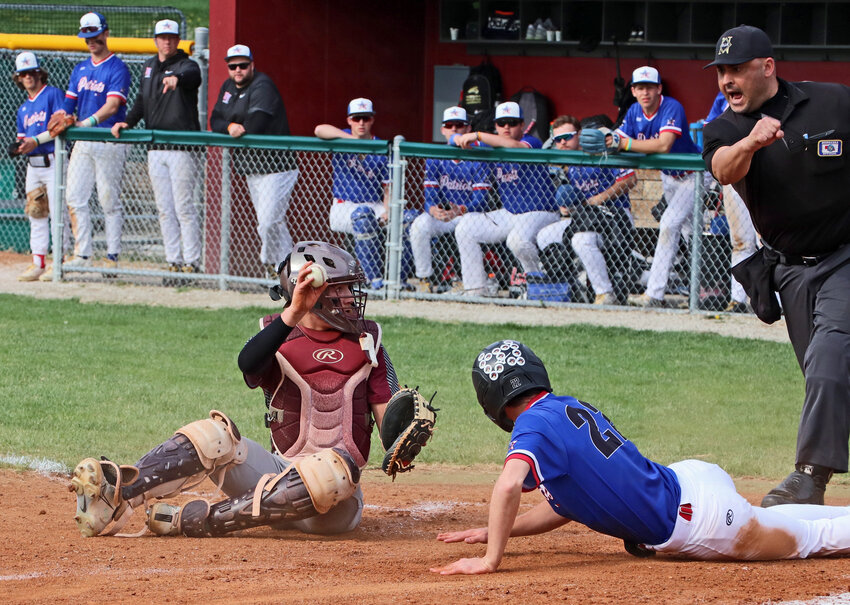 Arlington catcher Braden Monke, left, shows the umpire the ball for an out call Tuesday against Platte Valley at the Washington County Fairgrounds.