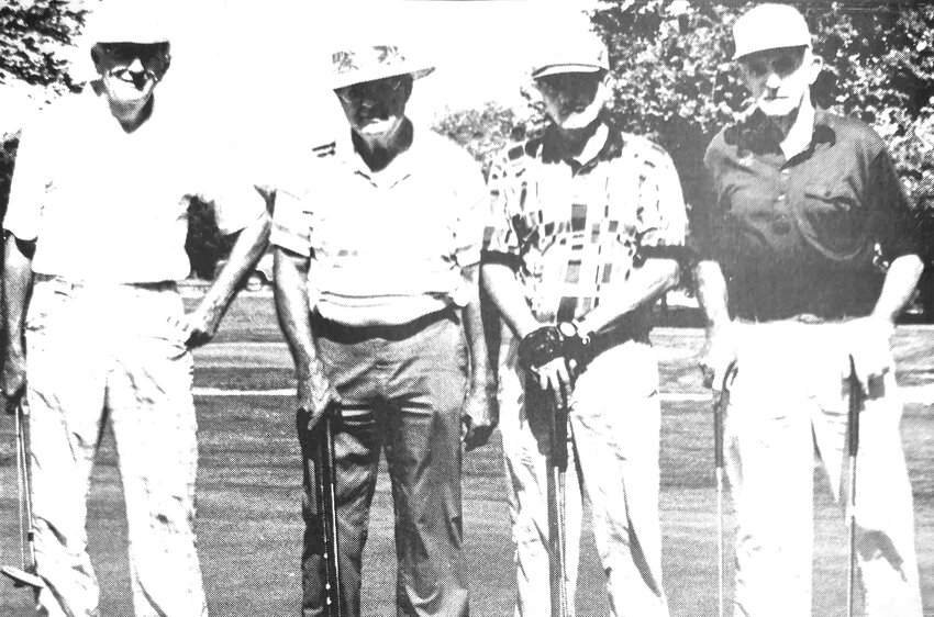 Bob Macholan, from left, Dr. Les Grace, Steve Tucker and Joe Fitch pose for a photo at the Blair golf course in the mid-1990s. The four men played the Longest Day of Golf, finishing 102 holes.