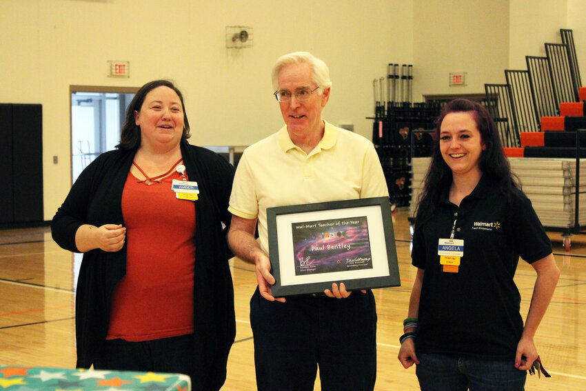 Paul Bentley, who has taught at Fort Calhoun High School for 42 years, was awarded the Walmart Teacher of the Year award during a special assembly Thursday morning in the Main Gym. Pictured with Bentley are Amber Udey, left, and Angela Roach of the Blair Walmart.