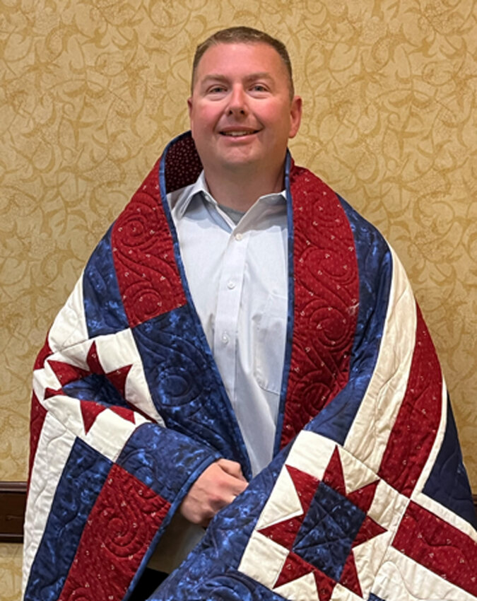 Scott McWhirter of Arlington joined the Army National Guard in June of 2001. He, alongside four others, received a Quilt of Valor during Nebraska Auctioneers AssociationThe Quilt of Valor Award Ceremony held at the 75th anniversary of the Nebraska Auctioneers Convention in Lincoln on April 30.