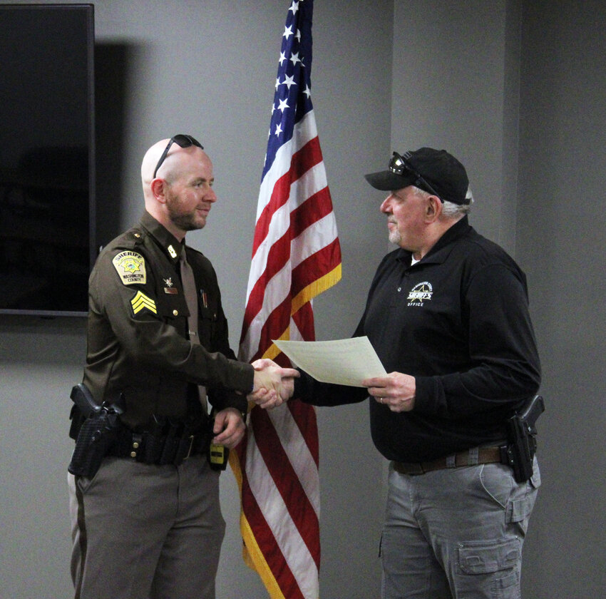 Coltin Bebensee, left, was promoted to sergeant Friday afternoon by Washington County Sheriff Mike Robinson.