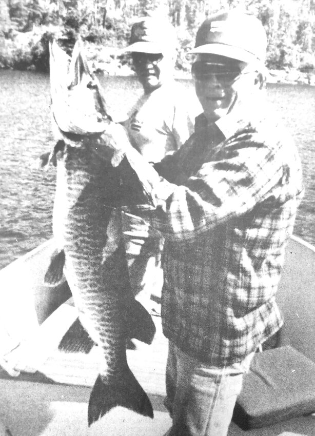 Frank Gabby of Blair finally caught a giant muskie in 1989. He was joined by Jim Scheffler, background, and was photographed by Daryl Miller.