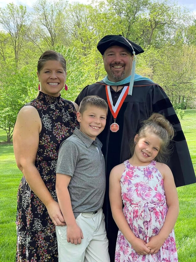 Nick Wemhoff, Fort Calhoun secondary principal, received his doctorate of education from Doane University on May 13. Pictured with Nick are his family: wife Amy and children Wyatt and Gwen.